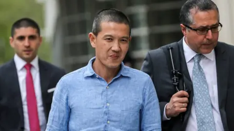 Reuters Ex-Goldman Sachs banker Roger Ng and his lawyer Marc Agnifilo leave the federal court in New York, U.S., May 6, 2019.