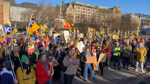 BBC People gather at a rally at The Mound in Edinburgh to protest against the government's new strikes bill