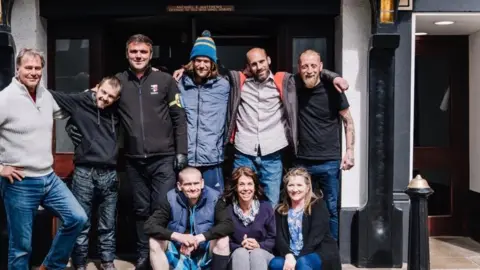 Mike Matthews Mr Matthews with staff and residents from the hotel