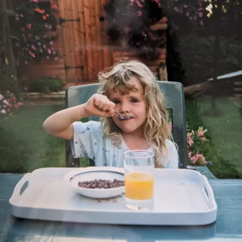 Loretta Harmes Loretta eating breakfast in her grandmother's garden