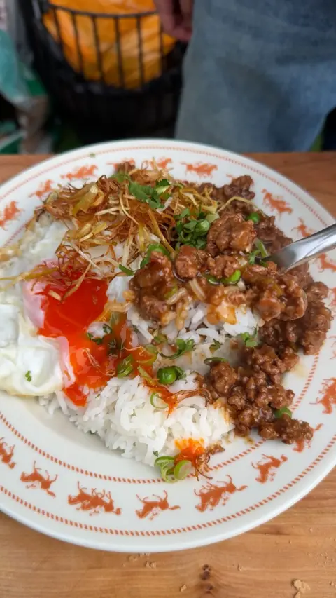 A white plate full of mince, rice and vegetables