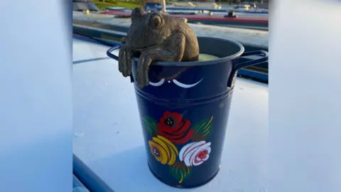 Rob Perryman A stone frog in a bucket - the boat's mascot