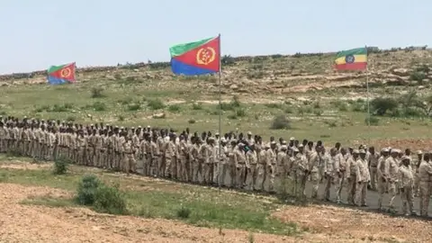 Eritrean soldiers wait in a line on September 11, 2018 to cross the border to attend the border reopening ceremony with Ethiopians as two land border crossings