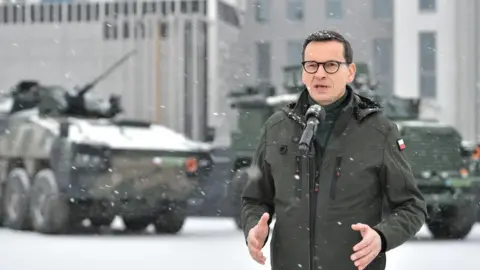 EPA-EFE/REX/Shutterstock Polish Prime Minister Mateusz Morawiecki at a news conference during a visit to the 18th Mechanised Division in Siedlce, eastern Poland, on 30 January 2023