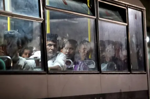 Domenic Aquilina/EPA Migrants, rescued at sea by the Italian coastguard, are driven away on police buses after disembarking at the Armed Forces of Malta maritime base in Floriana, Malta. 17 September 2019