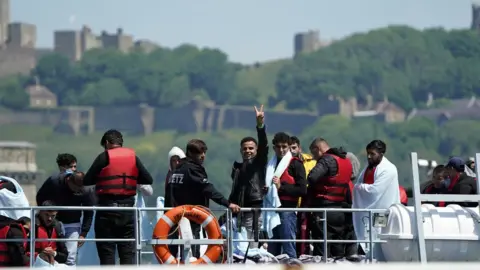 PA Media Migrants arriving at Dover