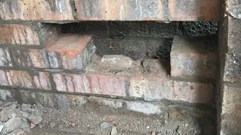 South Wales Fire and Rescue Service Bricks were removed from the garage