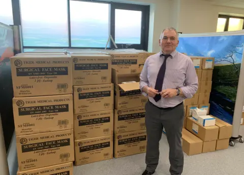 John Wright Alex Brown with boxes of masks