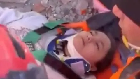 Reuters A teenage girl is pulled alive from the rubble