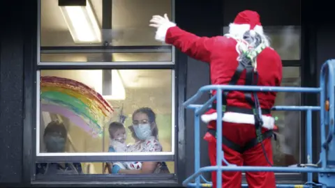 PA Media Santa made covid-safe hospital visits using a cherry picker