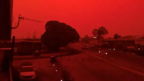 @brendanh_au/REUTERS Red skies descend over Mallacoota, Victoria, Australia on 4 January