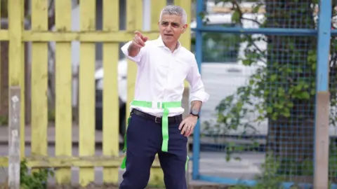 PA Media Sadiq Khan plays tag football at a school during the general election campaign