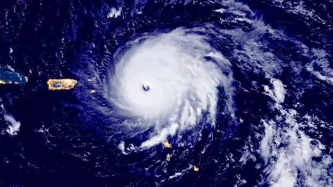Getty Images A satellite image of Hurricane Irma hitting the island of Barbuda in September 2017