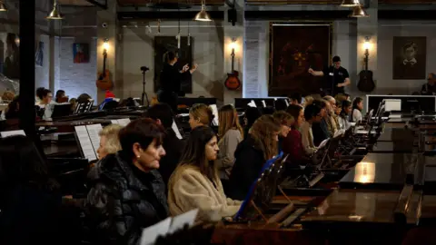 People playing 111 pianos in Nottinghamshire