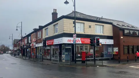 Photograph of the Re:dish Good Stuff social supermarket in Stockport. The image is taken on Gorton Road in Reddish.
