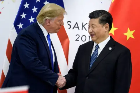 Getty Images Former US President Donald Trump (L) shakes hands with Chinese President Xi Jinping (R) on 28 June, 2019 at the G20 Summit in Osaka