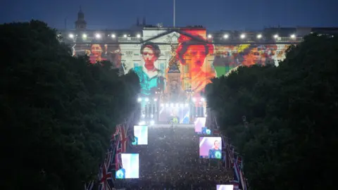 PA Media Buckingham Palace with projections on the Queen for the Platinum Party at the Palace