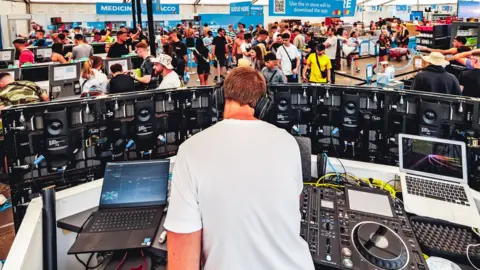 Geoffrey Hubbel DJ playing in supermarket at Creamfields North