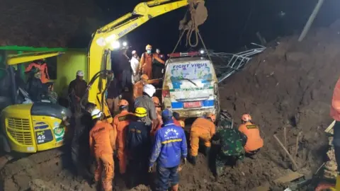 EPA An ambulance is lifted from the mud after it was buried in a landslide in Sumedang, West Java, Indonesia, 9 January 2021