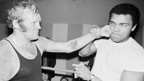 Mirrorpix/Getty Richard Dunn and Muhammad Ali