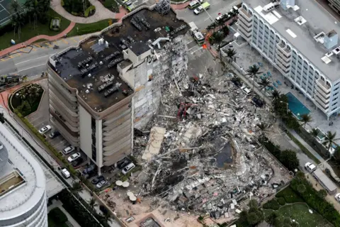 Reuters An aerial view showing a partially collapsed building in Surfside near Miami Beach, Florida, US, 24 June 2021.