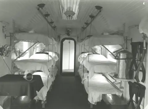 National Railway Museum Black and white photo of several beds inside a hospital train