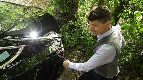 Getty Images Charging a green vehicle