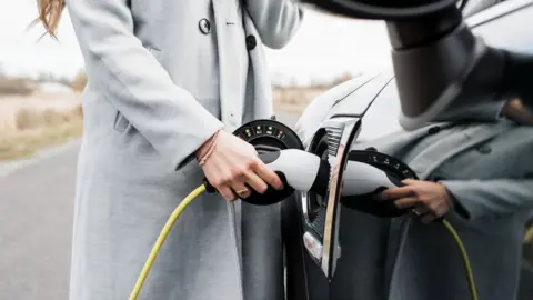 Getty Images Woman plus in electric car