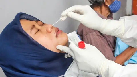 EPA Indonesian woman getting swab test