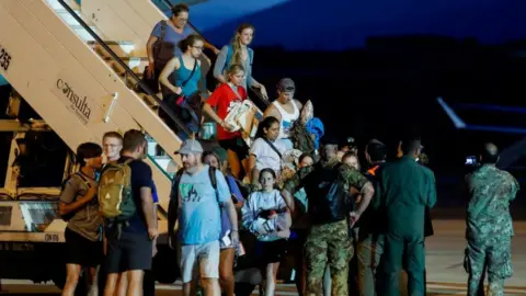 Reuters Evacuees from Niger seen disembarking an Italian flight in Rome