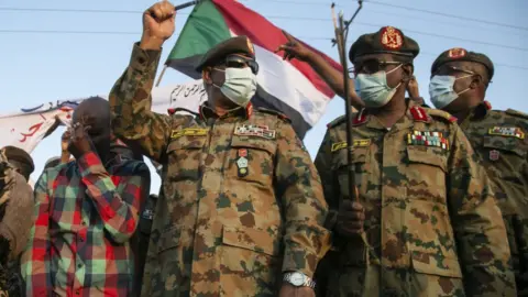 Getty Images Sudanese Army's deputy chief of staff, Lieutenant General Khaled Abdin al-Shami (2nd L), is seen ahead of his speech to the press as Sudanese army has retaken control of an area in the al-Fashqa border region with Ethiopia on December 29, 2020, in eastern Al -Qadarif State, Sudan.