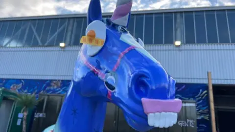 A blue unicorn with a Haribo egg for eyes and Haribo teeth