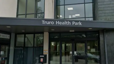 A picture of the entrance to the health park in Truro. There is glass doors and a window, with an automatic door entrance,