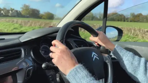 BBC News Driving through the countryside.