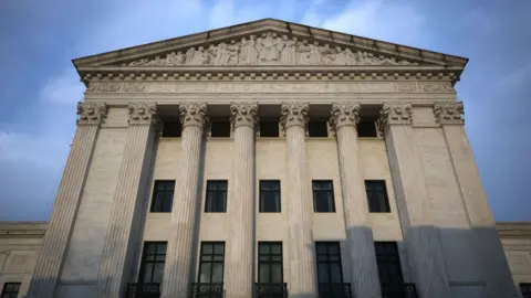 Sunlight hits the front columns of the Supreme Court building in Washington, DC.