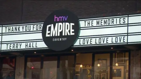 Coventry's HMV Empire with tribute on billboard to Terry Hall