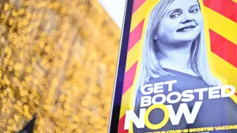 Getty Images Get booster now sign