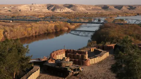 Reuters A Turkish army tank is positioned at a military post by the Euphrates river on the Turkish-Syrian border in Karkamis in Gaziantep province, Turkey, December 13, 2017.