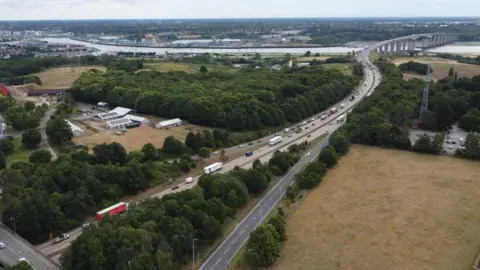 John Fairhall/BBC An aerial view of the A14 heading towards the Orwell Bridge.