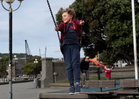 AFP/Getty Images A child plays on a swing at a park in Wellington on 14 May, 2020.