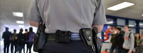 The Washington Post Armed officer in school hallway