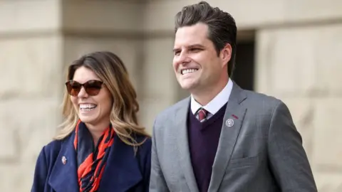 Getty Images Representative Matt Gaetz walks with his fiancée Ginger Luckey