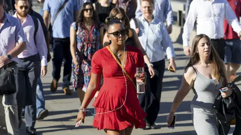 Getty Images Commuters carrying water on train and underground services