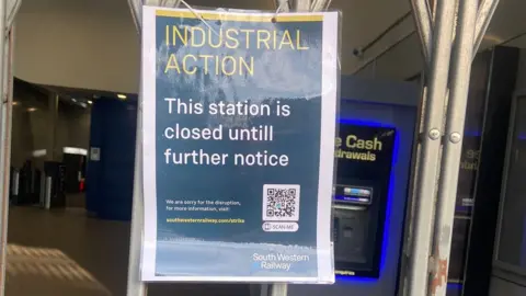 Kate Goudsmit/Twitter A photo of the shuttered entrance to Earlsfield station with an SWR notice saying it is closed "until further notice"