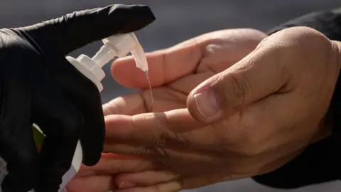 Getty Images File image of liquid sanitiser being squirted on someone's hands