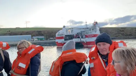 Dana Craigie Passengers on lifeboat with ferry in background