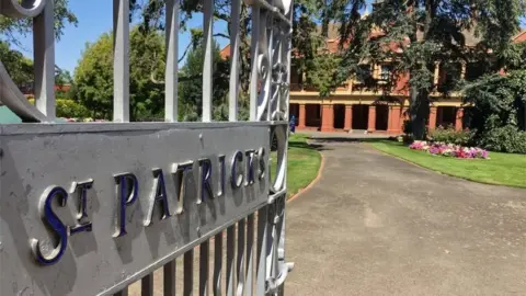 Reuters A gate reads "St Patrick's" in front of school grounds and a building