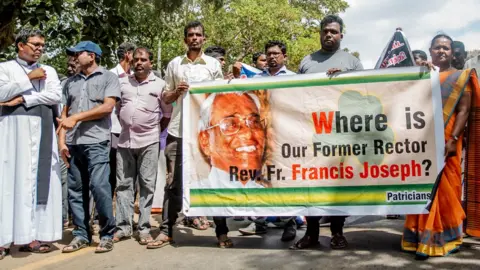 BBC/Elaine Jung Protesters holding a banner in Killinochchi, northern Sri Lanka