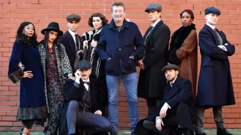 Getty Images Peaky Blinders creator Steven Knight (centre) with dancers from Rambert's Peaky Blinders ballet