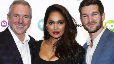 Getty Images Former Neighbours actress Sharon Johal (centre) with castmates Alan Fletcher and Bell Hall